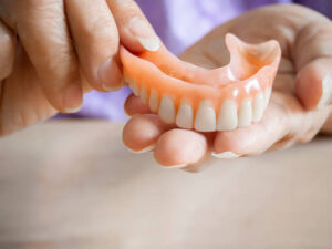 Close up of denture in hand